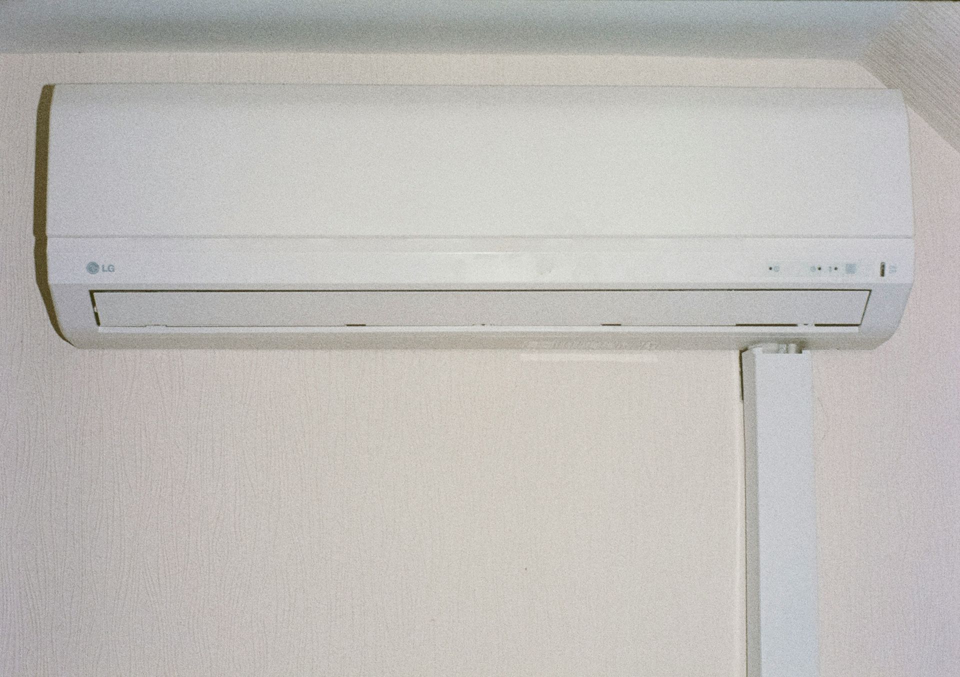 A white air conditioner mounted on a wall